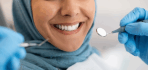 Woman smiling as dentist examines her teeth